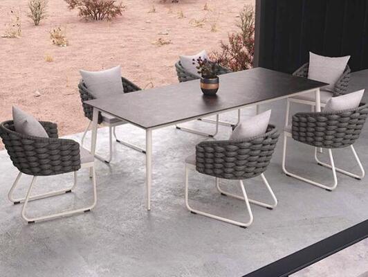 Outdoor table and 6pcs chairs crafted from weather resistant UV rope and aluminum frame perfect for in gardens courtyards and villa outdoor spaces